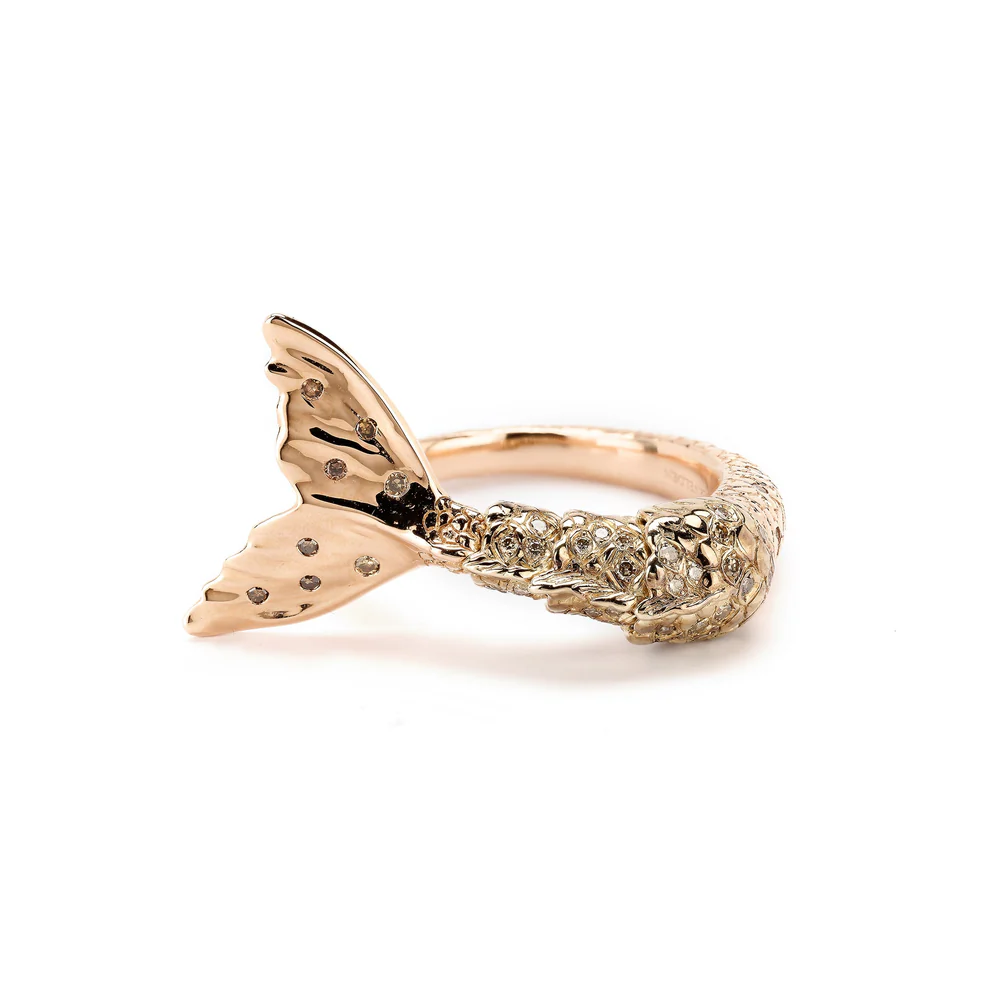 Close-up of 18K rose and white gold Mermaid Tail Twist Ring by Bibi van der Velden, showcasing sculpted mermaid tail details and single-cut brown diamonds