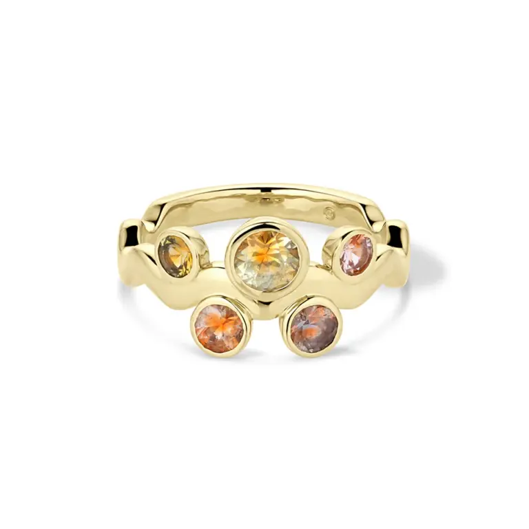 The Cadlina Wavy Montana Sapphire Ring worn on a finger, illustrating its vibrant, fluid design and refined yet playful character.