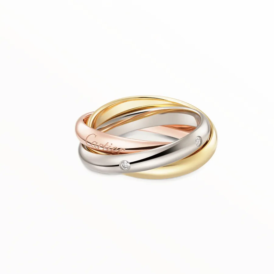 Cartier Trinity ring classic model with three intertwined bands in white, yellow, and rose gold, set with five brilliant-cut diamonds.