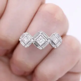 Taylor Custom Rings Darby engagement ring with three princess-cut lab-grown diamonds on point and baguette-plus-round halo