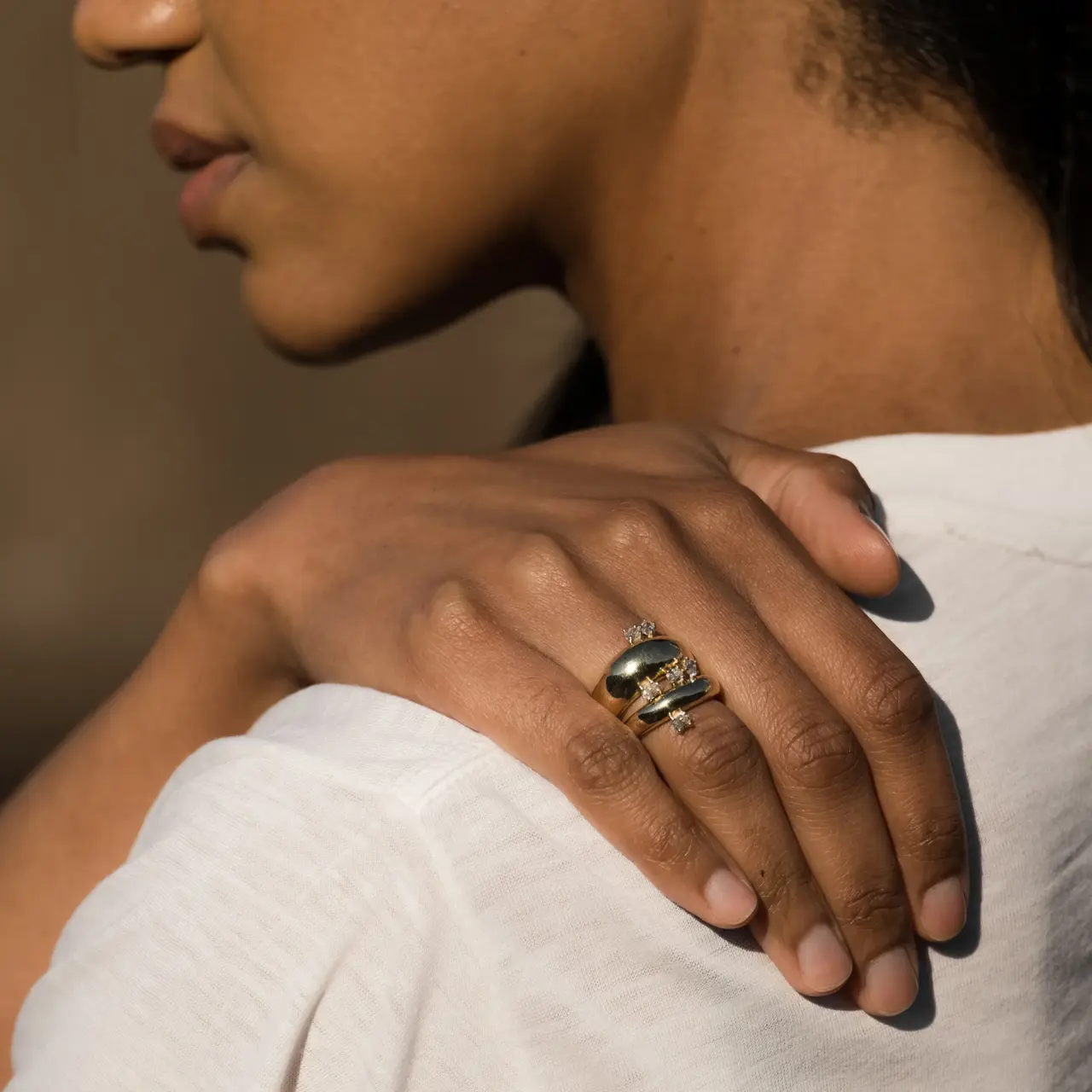 Side view of Grace Lee Demi Globe Plus Ring with oval diamonds arranged in a horizontal row on a gold dome