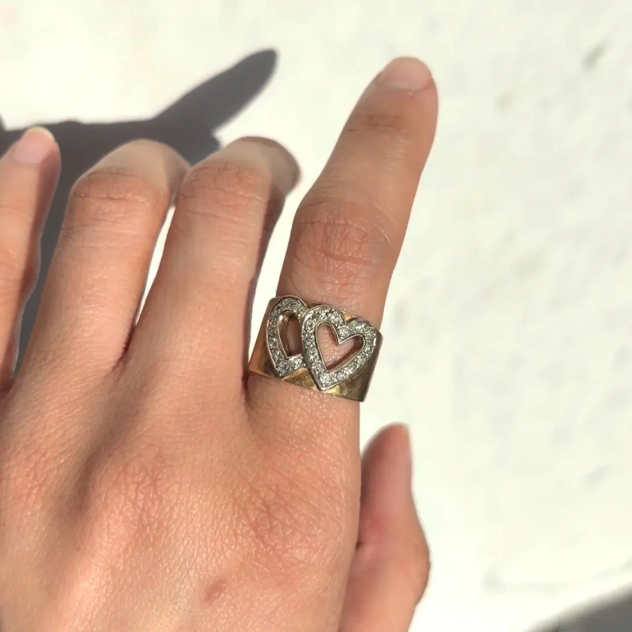 Double hearted vintage ring on a finger