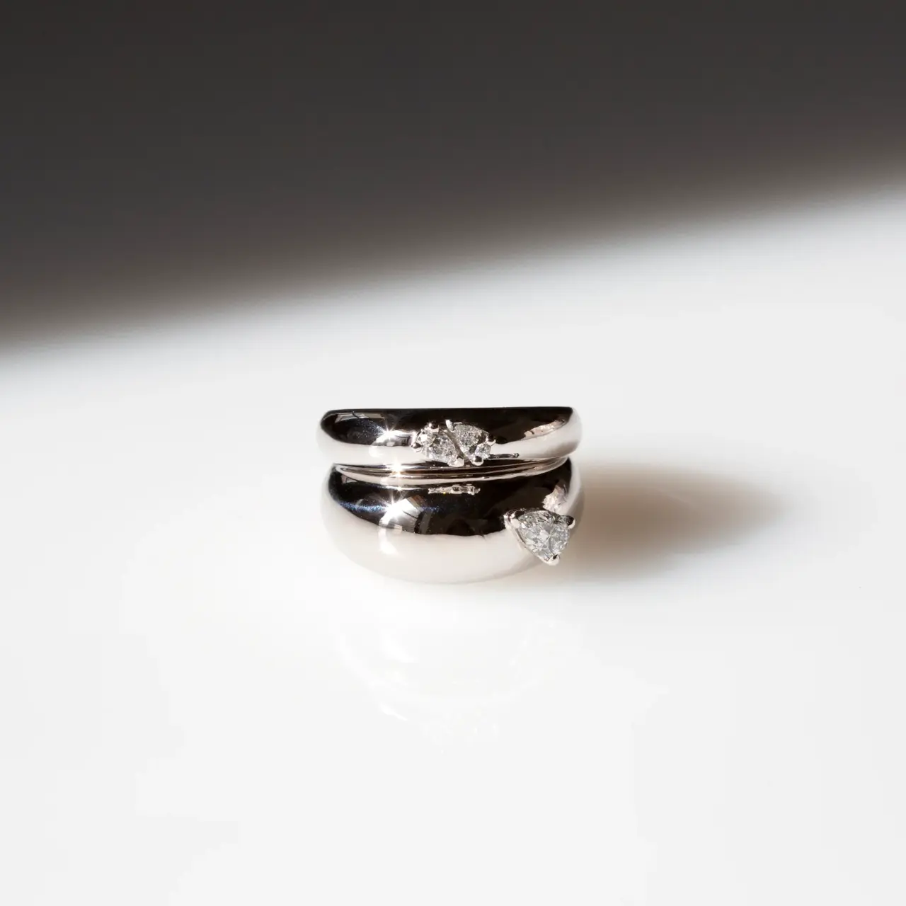 Model wearing the Grace Lee Double Pear Demi Demi ring in white gold, highlighting the simple yet striking twin pear‑shaped diamond design.
