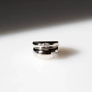 Model wearing the Grace Lee Double Pear Demi Demi ring in white gold, highlighting the simple yet striking twin pear‑shaped diamond design.