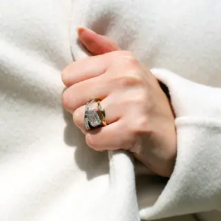 Close-up of Grace Lee’s wave band in white gold featuring a pear diamond in a high crest setting