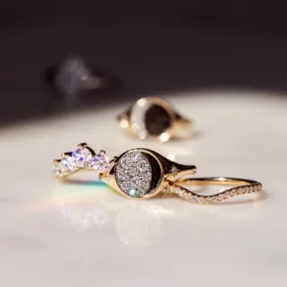 Detailed view of a Gibbous Moon Signet Ring in 14k yellow/white/rose gold, accented with .30 ct of natural diamonds in a moon‑phase design.