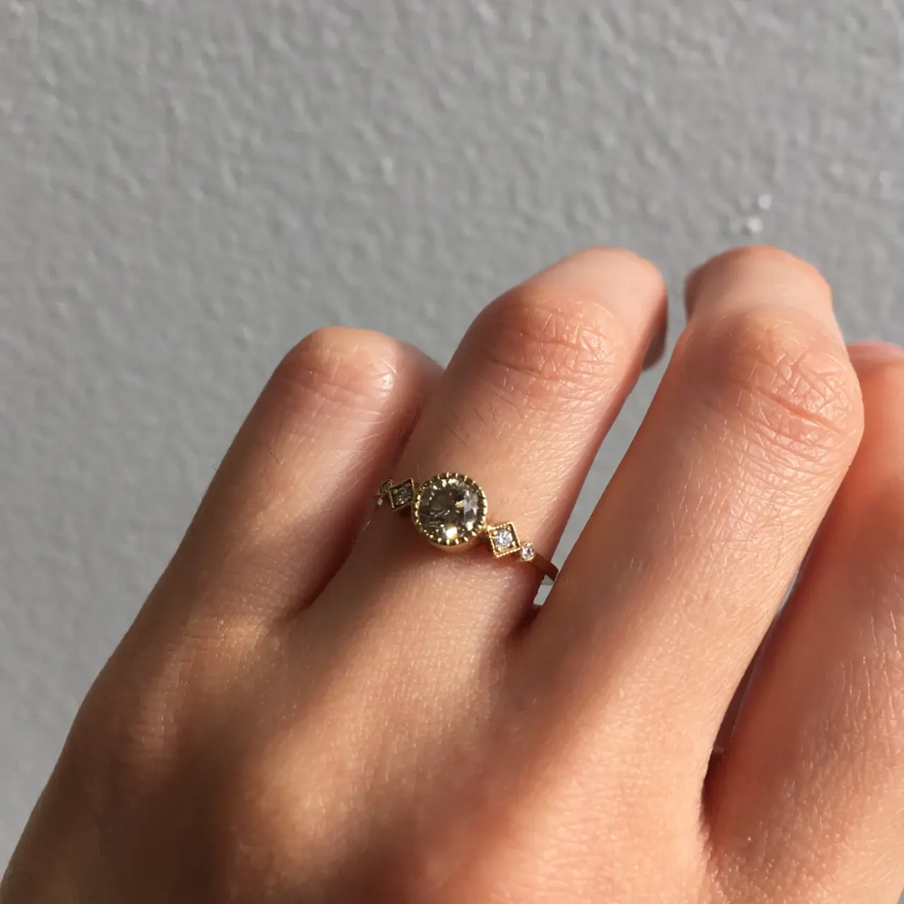 Jennie Kwon Echo ring featuring round champagne diamond in hand-detailed gold setting