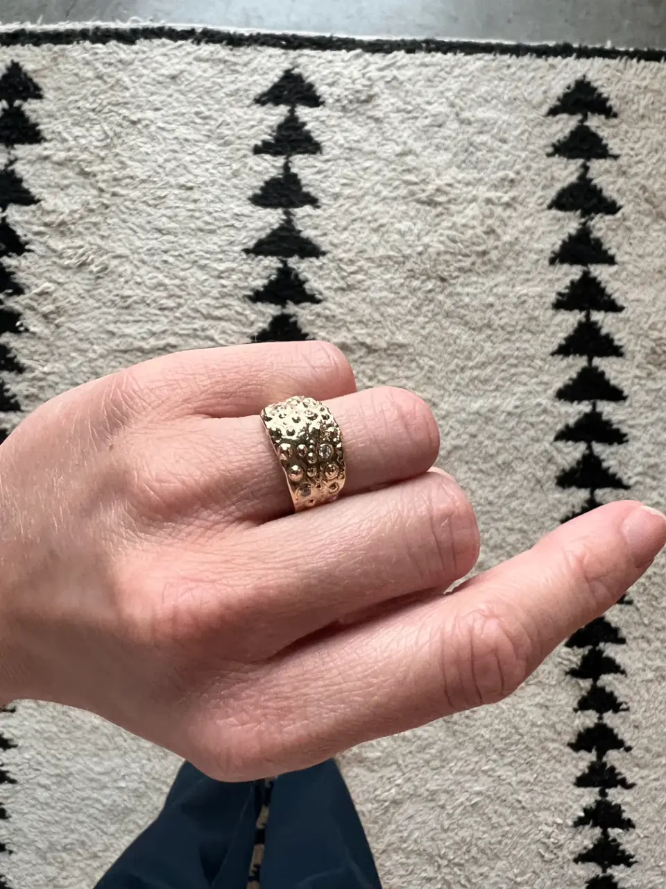 Unique textured gold ring with undulating, natural-inspired form and matte finish.