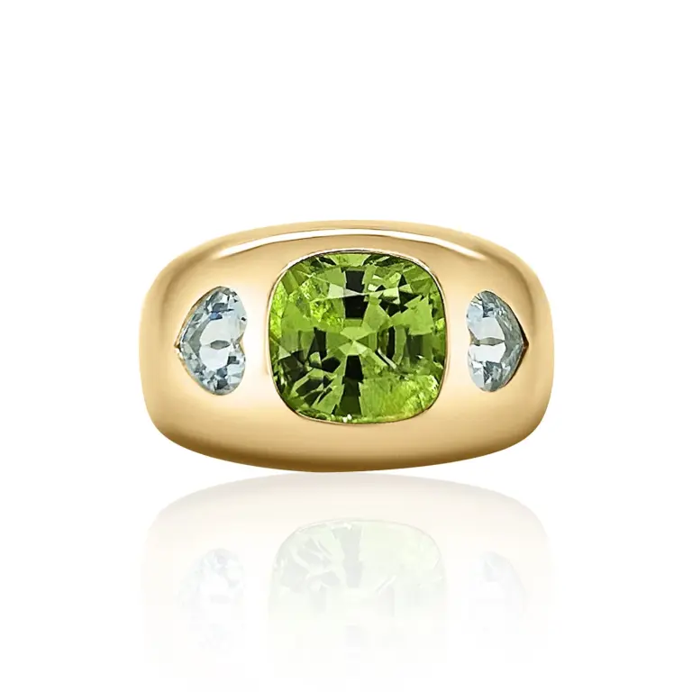 The bold Nomad ring featuring peridot and aquamarine nestled elegantly in a luxe presentation box.