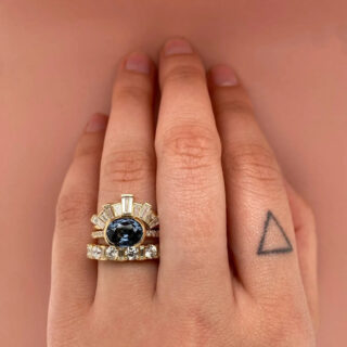 Elegant Estrada engagement ring displaying a rich 2.31 ct gray‑blue spinel set east‑west in a delicate 14k bezel, complemented by a half‑band of sparkling .09 ctw SI G‑H diamonds for balanced contrast.”