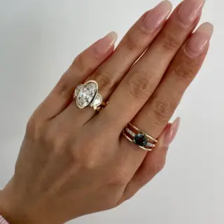 Side view of Orianne three‑stone ring featuring low‑set oval and half‑moon lab diamonds in 14K yellow gold.