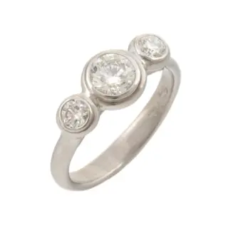 Platinum Lunette-style three-stone engagement ring featuring a 0.64ct round brilliant center diamond (SI2 clarity, H color) and two 0.15ct side diamonds (VS2 clarity, F-G color), totaling 0.94ct in diamond weight