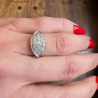 Side view of vintage 1930s Art Deco eye-shaped diamond cluster ring with slender, pinched shoulders on a slim band