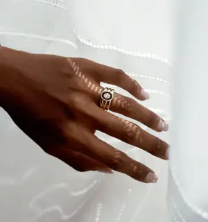 Modern architectural signet ring by J.Hannah featuring a black onyx inlay and recycled diamond in a triple-ridged 14k gold band.