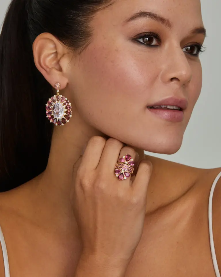 Model wearing 18K yellow gold pear-shaped pink tourmaline and diamond ring, highlighting its delicate design and radiant gemstone
