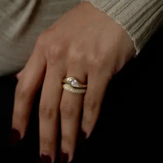 Side profile of the Marlow East-West Pear Ring highlighting its chunky domed band and flush east-west setting.