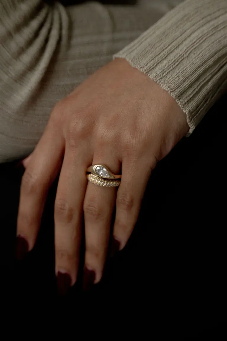 Side profile of the Marlow East-West Pear Ring highlighting its chunky domed band and flush east-west setting.