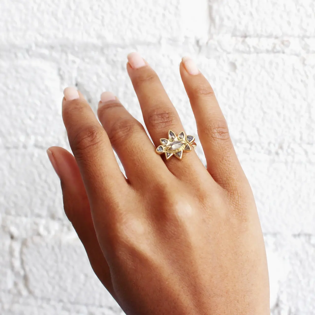 Lauren Wolf Jewelry Sunrise Ring featuring marquise-cut gray-green diamond, surrounded by pear and trillion-cut salt-and-pepper diamonds in 18k yellow gold.