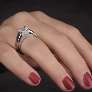 Close-up of the Love Manifesto Band, highlighting the emerald-cut diamond and the intricate pavé setting on the 14K gold band.