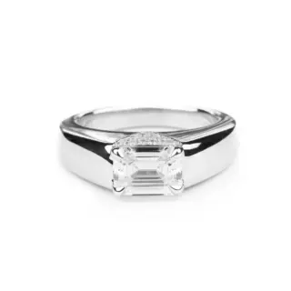 Front view of Magdalene Pivoine's Love Manifesto Band, showcasing an emerald-cut diamond set in a V-shaped pavé band in 14K gold