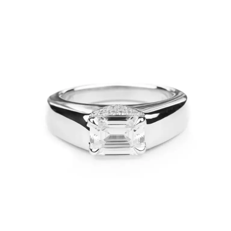 Front view of Magdalene Pivoine's Love Manifesto Band, showcasing an emerald-cut diamond set in a V-shaped pavé band in 14K gold