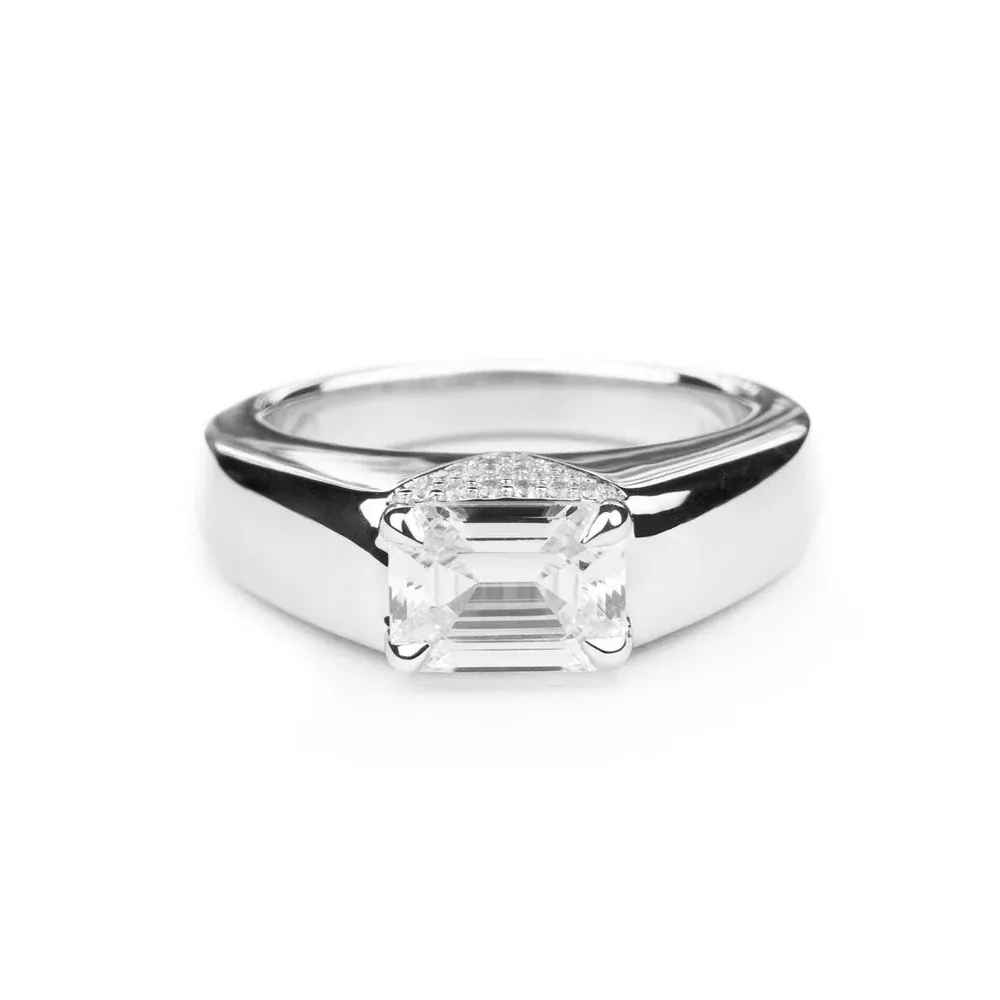 Front view of Magdalene Pivoine's Love Manifesto Band, showcasing an emerald-cut diamond set in a V-shaped pavé band in 14K gold