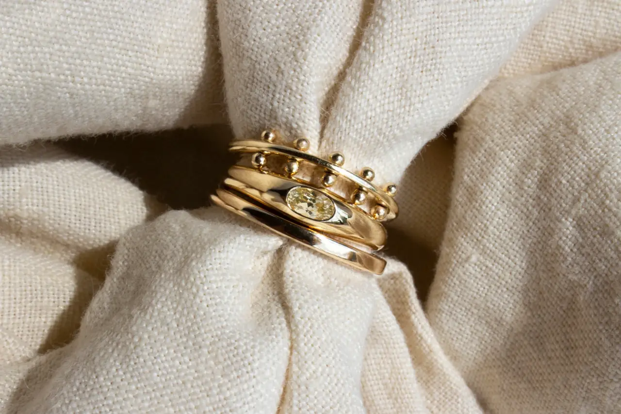 Yellow Sapphire Petite Risa Ring on a finger, emphasizing its sleek design and ethical craftsmanship.