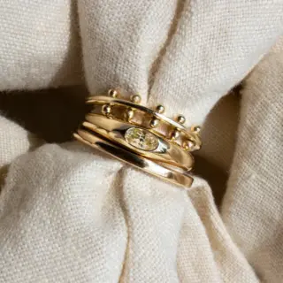 Yellow Sapphire Petite Risa Ring on a finger, emphasizing its sleek design and ethical craftsmanship.