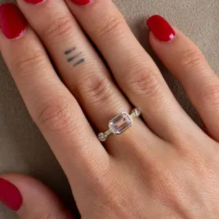 Close-up of Hikaru Ring No. 10: rose-pink sapphire center with delicate champagne diamond accents in yellow gold.