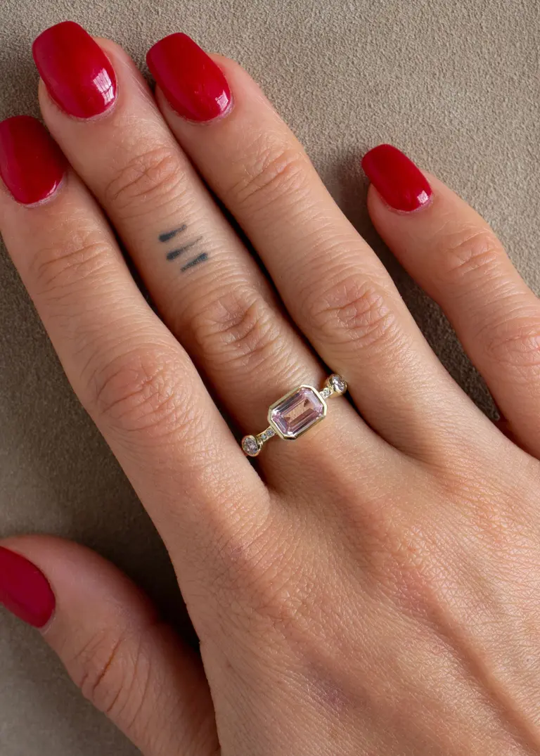 Close-up of Hikaru Ring No. 10: rose-pink sapphire center with delicate champagne diamond accents in yellow gold.