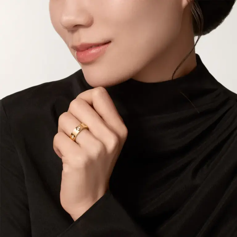 Close-up of Cartier’s Love Ring, highlighting the 6 diamonds and the polished rose gold finish, embodying timeless elegance.