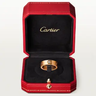 Cartier Love Ring worn on hand, illustrating its classic design and the sparkling diamonds set in rose gold.