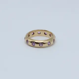 Pink sapphire mosaic ring worn on hand, illustrating its bold color palette, artisanal craftsmanship, and stackable 5mm profile