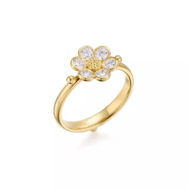 Close-up of 18K yellow gold Diamond Fiori Ring with sparkling brilliant-cut diamonds and detailed gold granulation, inspired by floral motifs