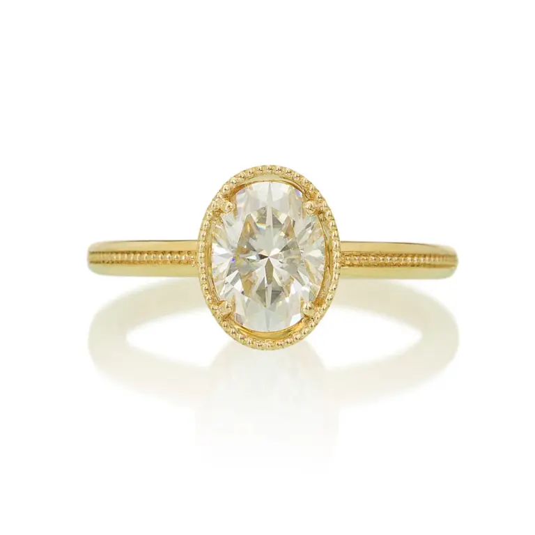 1.5 ct oval diamond Art Deco engagement ring in 14k gold, featuring milgrain detail, angular openwork basket, and six blue sapphires set into the filigree for vintage elegance