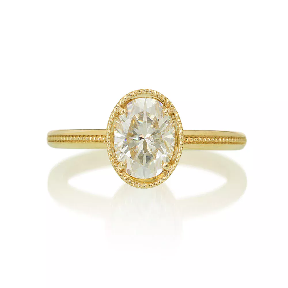 1.5 ct oval diamond Art Deco engagement ring in 14k gold, featuring milgrain detail, angular openwork basket, and six blue sapphires set into the filigree for vintage elegance