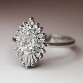 Side view of the Rhapsody 15mm ring, emphasizing the detailed band and diamond halo surrounding the central GIA-certified diamond.