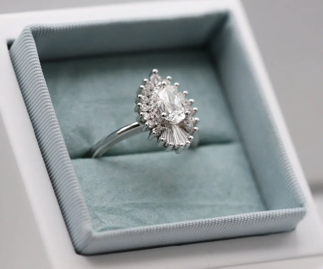 Heidi Gibson's Rhapsody 15mm ring displayed on a stand, showcasing its luxurious design and sparkling natural diamonds in 14k white gold