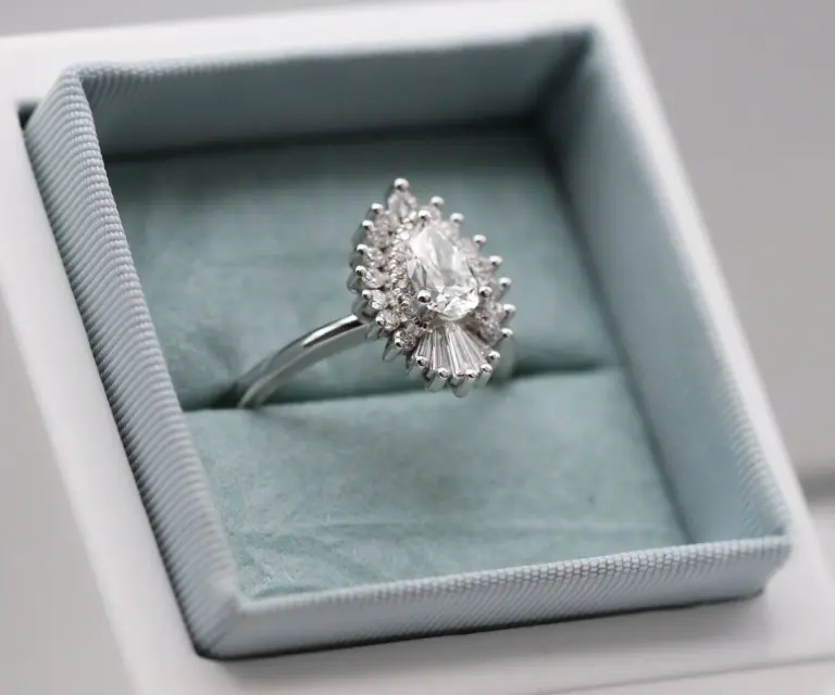 Heidi Gibson's Rhapsody 15mm ring displayed on a stand, showcasing its luxurious design and sparkling natural diamonds in 14k white gold