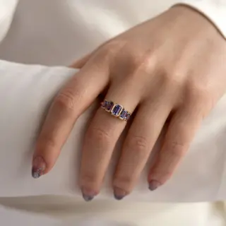 Handcrafted Juno Ring with five indigo blue emerald-cut tanzanites in a 14k gold open bezel setting