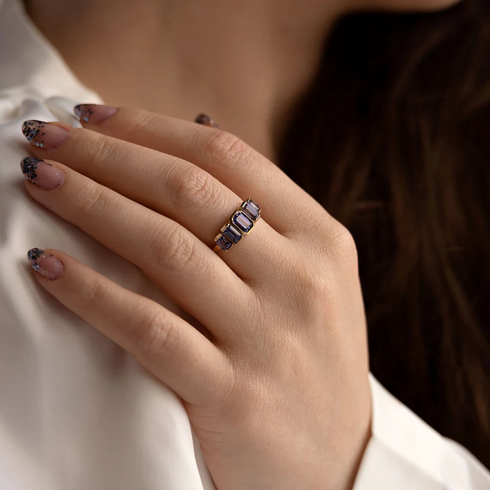 Elegant Juno Ring by Oma Jewelry, showcasing five emerald-cut tanzanite stones in 14k gold