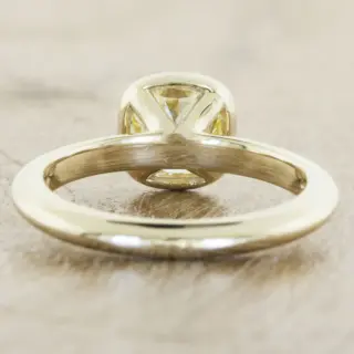 Unique bezel-set solitaire engagement ring with oval diamond, perfect for a modern and stylish proposal.