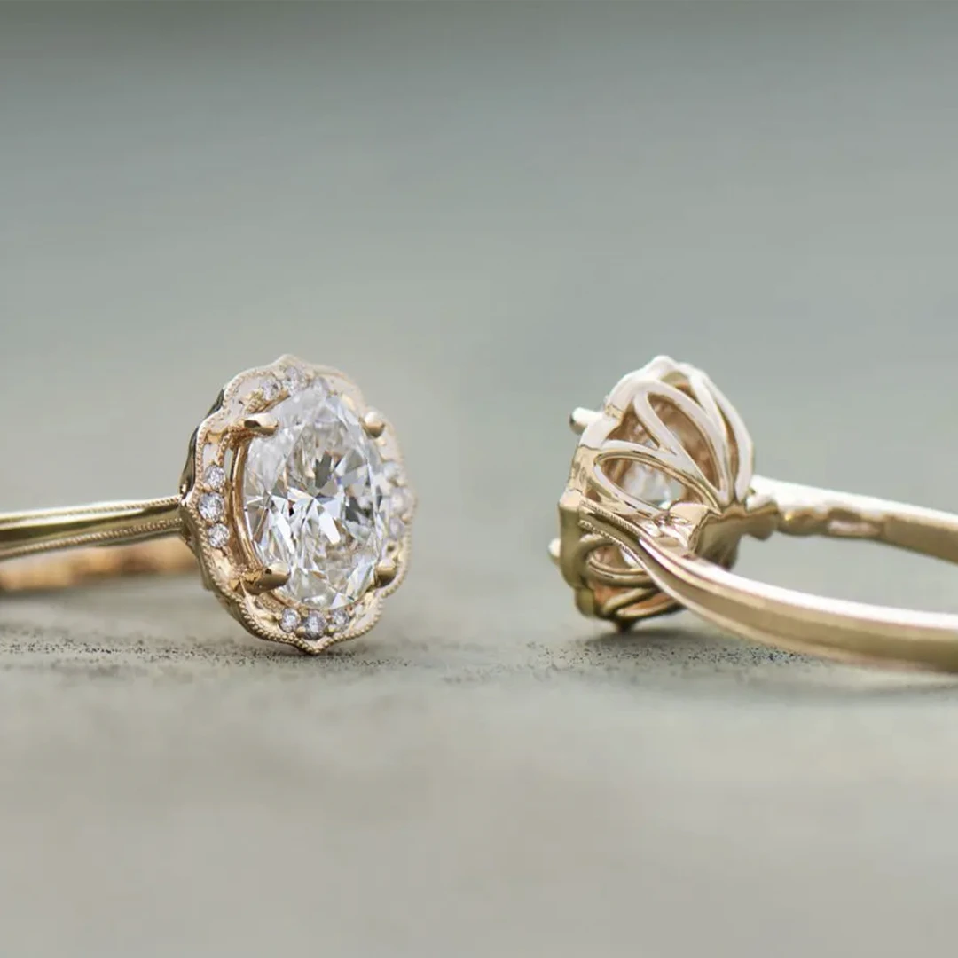 Side view of Daisy Blossom engagement ring with daisy petal under-gallery, vintage-style milgrain, and oval-cut center diamond