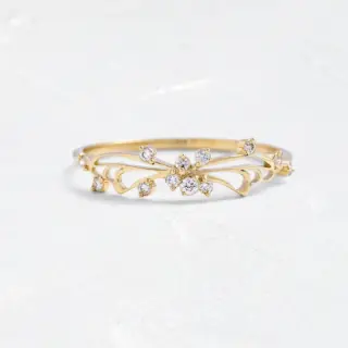 Diamond Small Changes Ring in 14k gold featuring delicate negative‑space swoops and twelve accent round diamonds (1–1.5 mm), evoking butterfly wing arches and artistic fluidity