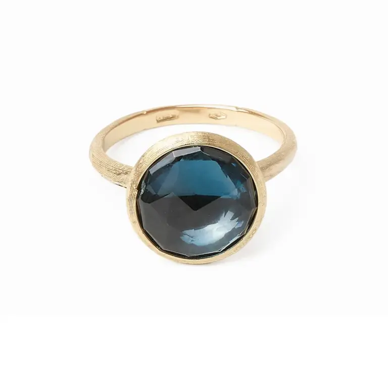 Marco Bicego Jaipur ring in 18K yellow gold featuring a round checkerboard-cut London blue topaz, hand-engraved with Florentine texture