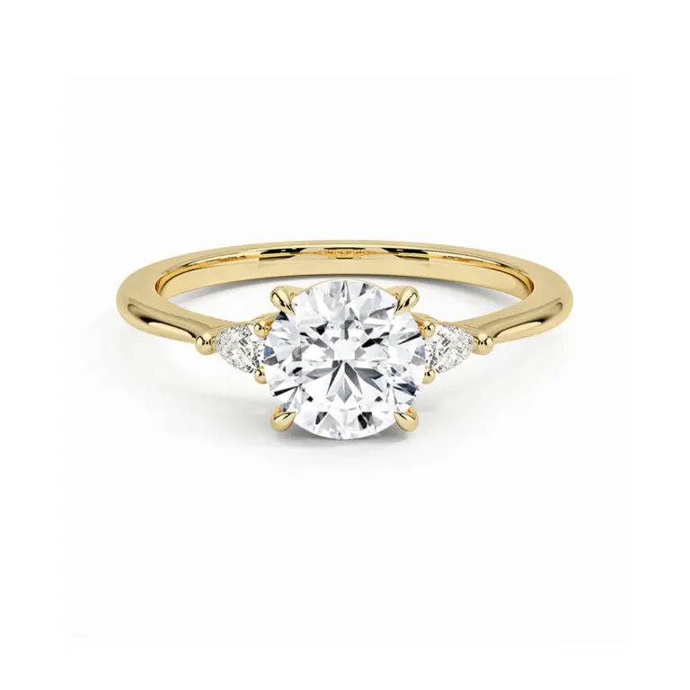 Aria three-stone engagement ring in 18k yellow gold with 1 carat round lab-grown diamond and pear-shaped side stones.