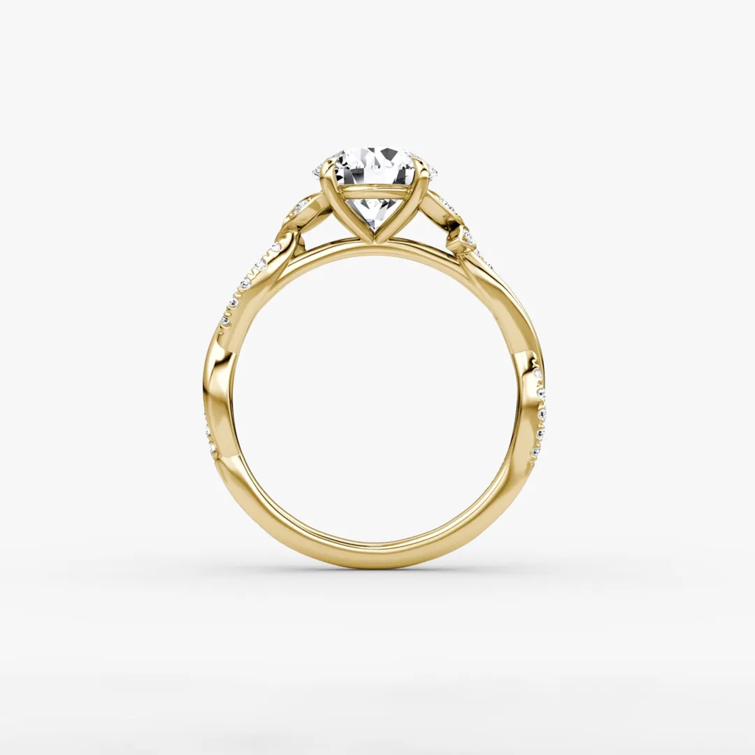 Elegant twisted band engagement ring with floral diamond accents and round center stone by VRAI Jewelry