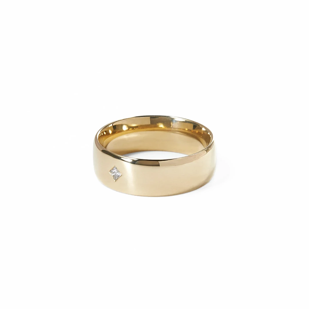 Yellow gold dome ring with flush princess diamond.