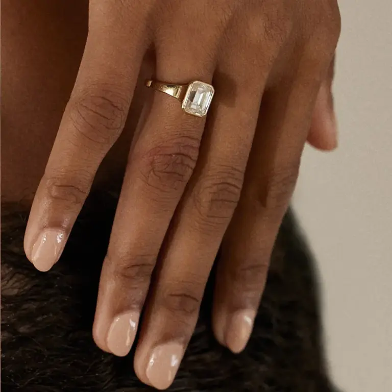 Close-up of emerald‑cut diamond framed within a clean octagonal bezel on the Cosma Ring, available in yellow, white, rose gold or platinum