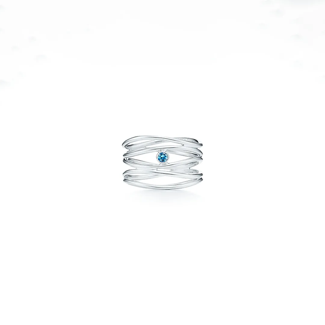 Tiffany Elsa Peretti Wave three‑row 18 kt gold ring with central round brilliant diamond (0.05 ct), featuring fluid wave‑shaped bands.